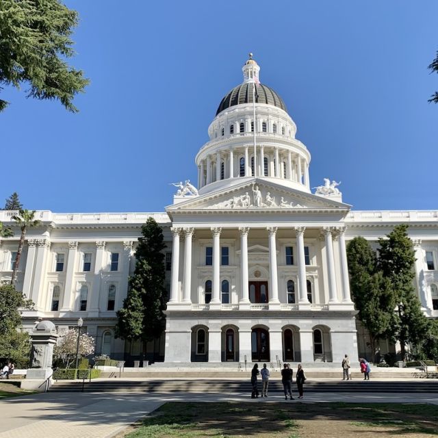 Photo of the California Capitol -- a white building with columns and dome