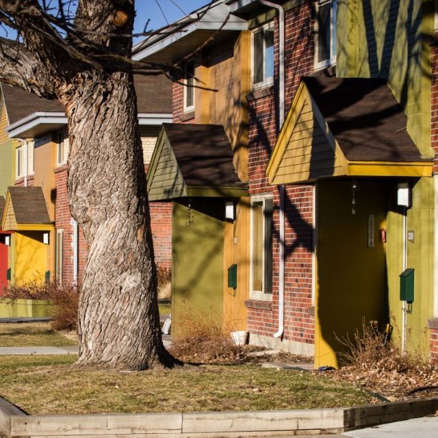 Red brick townhomes with colorful trimming
