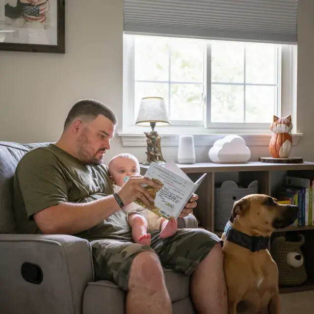 Veteran reading book to child