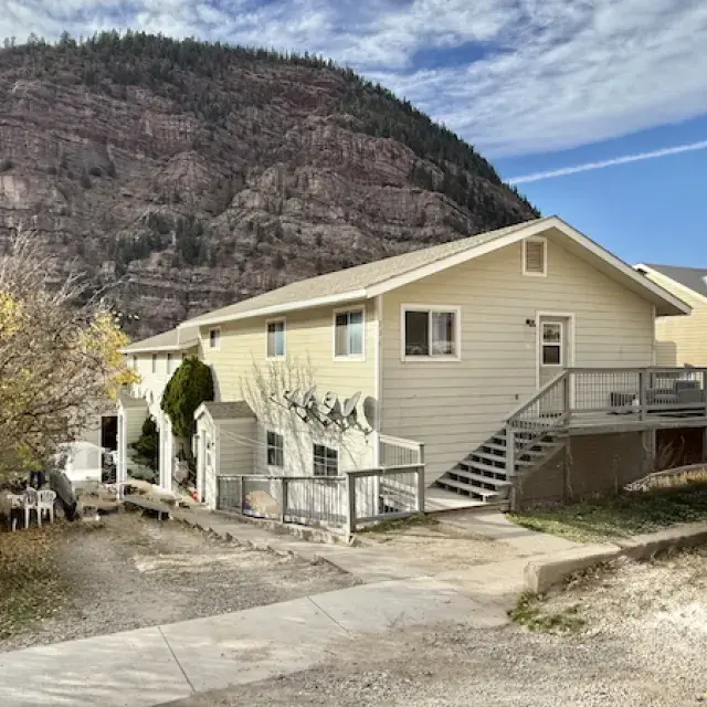 Yellow house with a mountain in the background