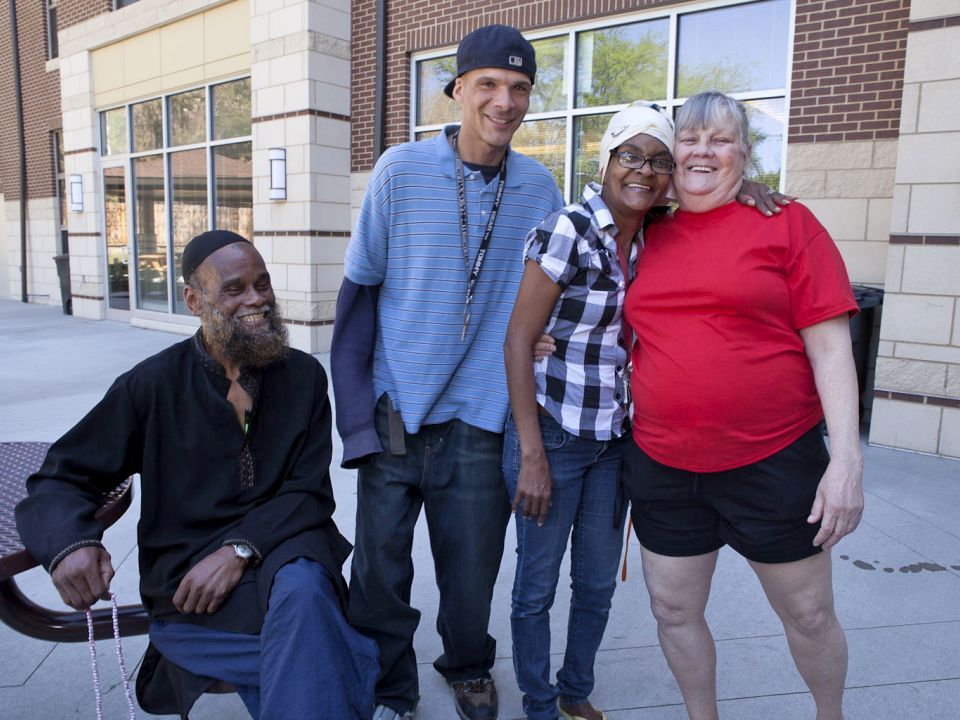 People posing for a photo outside in front of a building