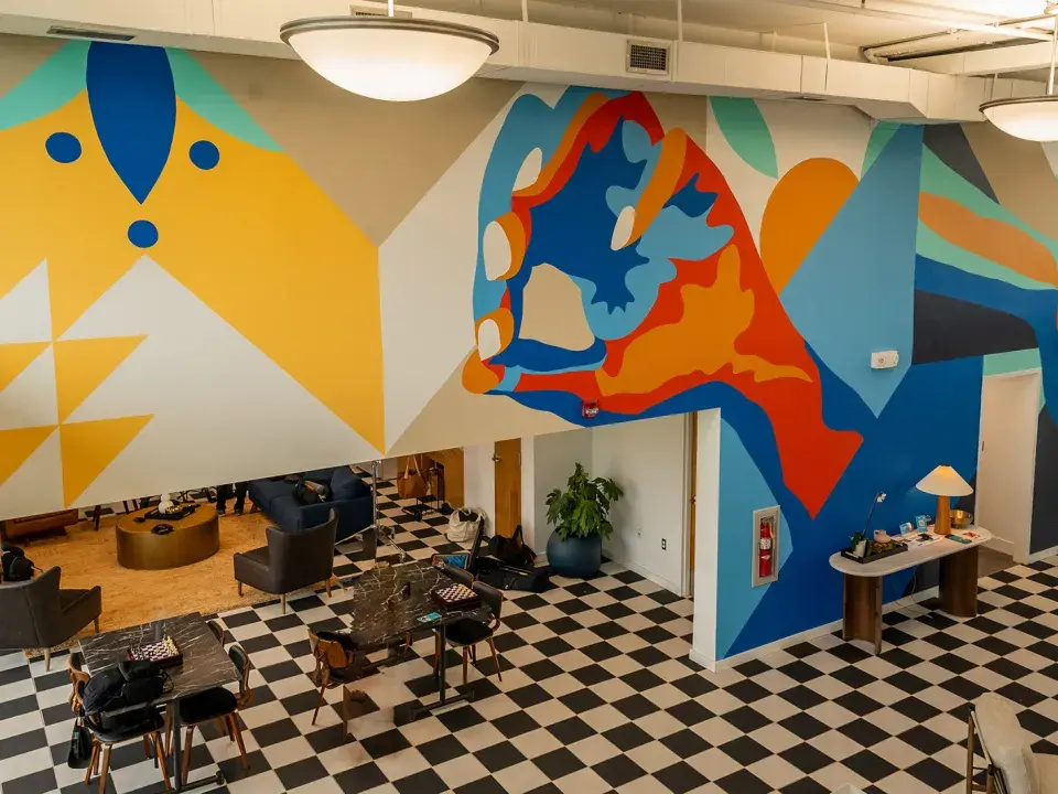 Colorful mural on an office wall and a black and white checkered floor