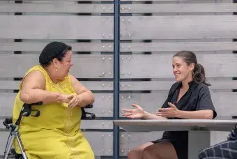 Three women sitting at a table talking