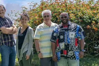 A group of five people standing outside